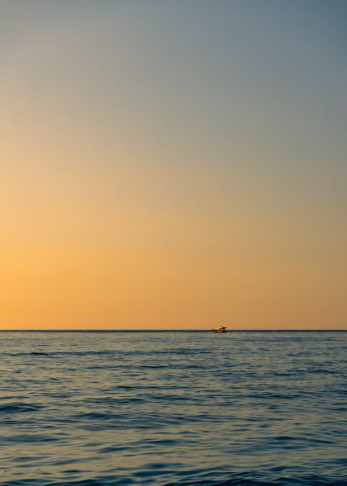 Boat on Calm Sea at Sunset