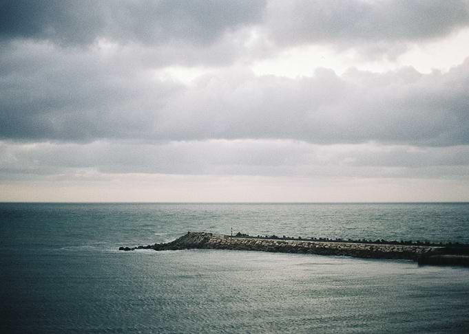 Seawall Under Cloudy Sky