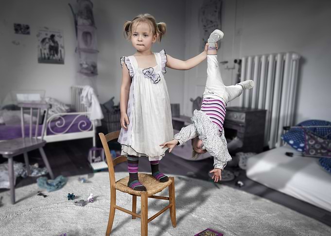 Playful Sisters in Messy Room