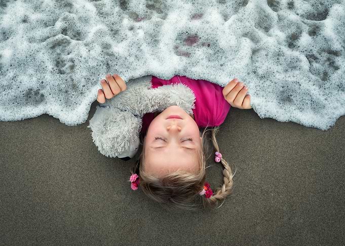 Girl Sleeping in Ocean Foam