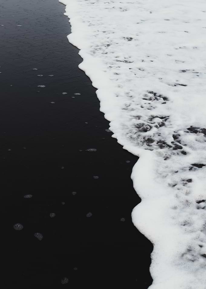 Black sand beach wave