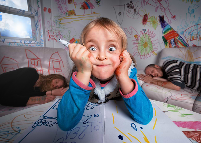 Playful Child with Parents Asleep