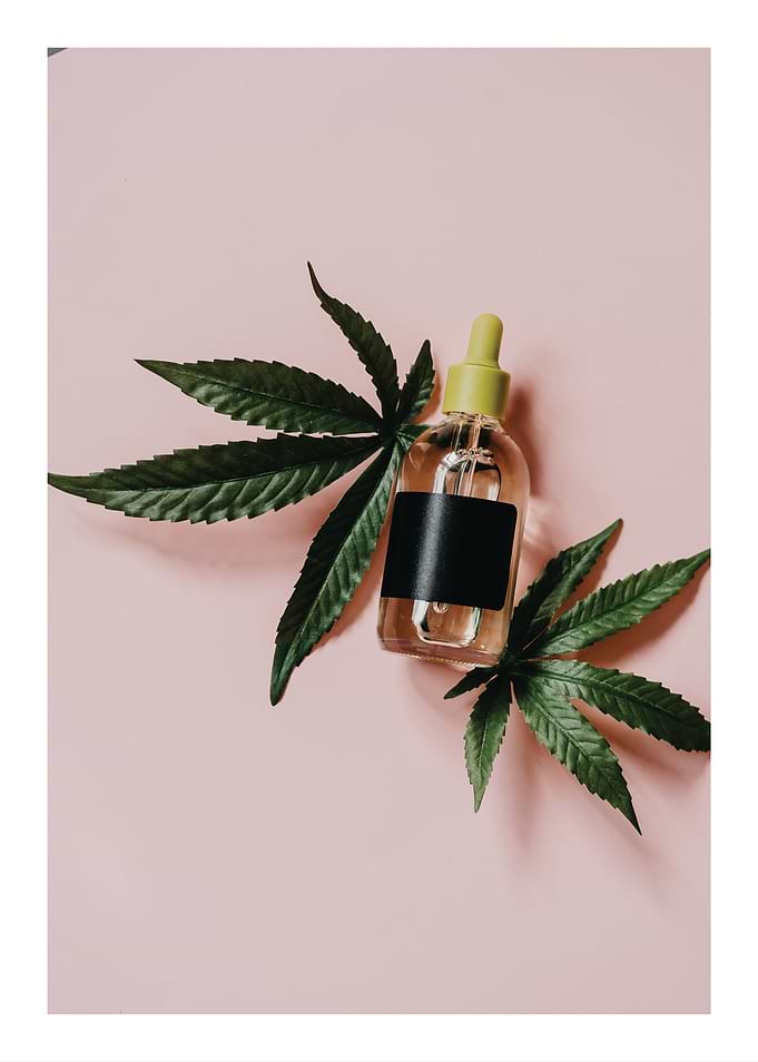 CBD Oil Bottle with Cannabis Leaves