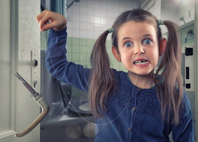 Girl Pulling Loose Tooth