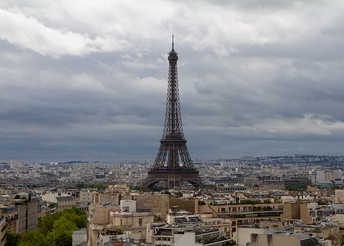 Eiffel Tower surrounded by buildings of the city of Paris
