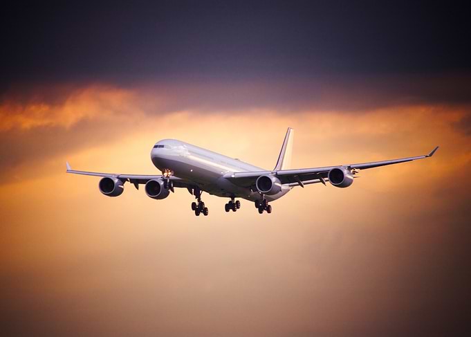 Airplane Landing at Sunset