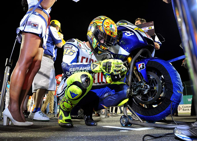 MotoGP Racer Kneeling by Bike