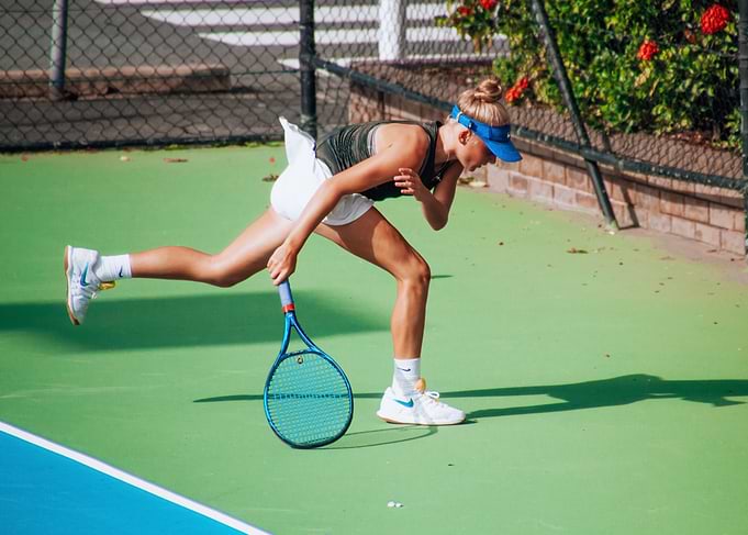 Tennis Player Reaching for Ball