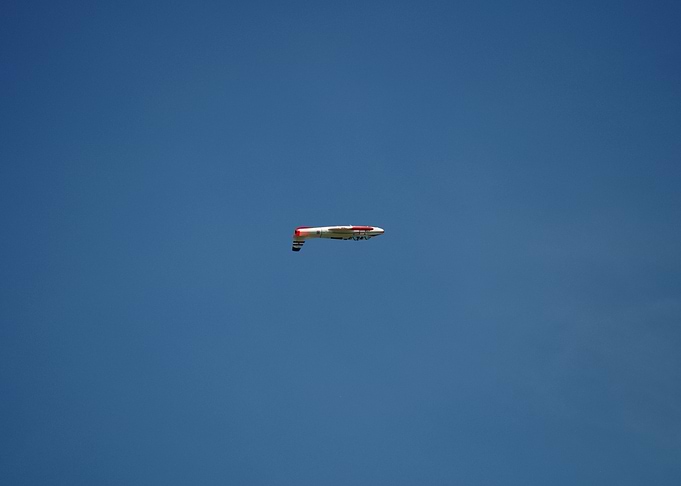Plane in Blue Sky flying upside down