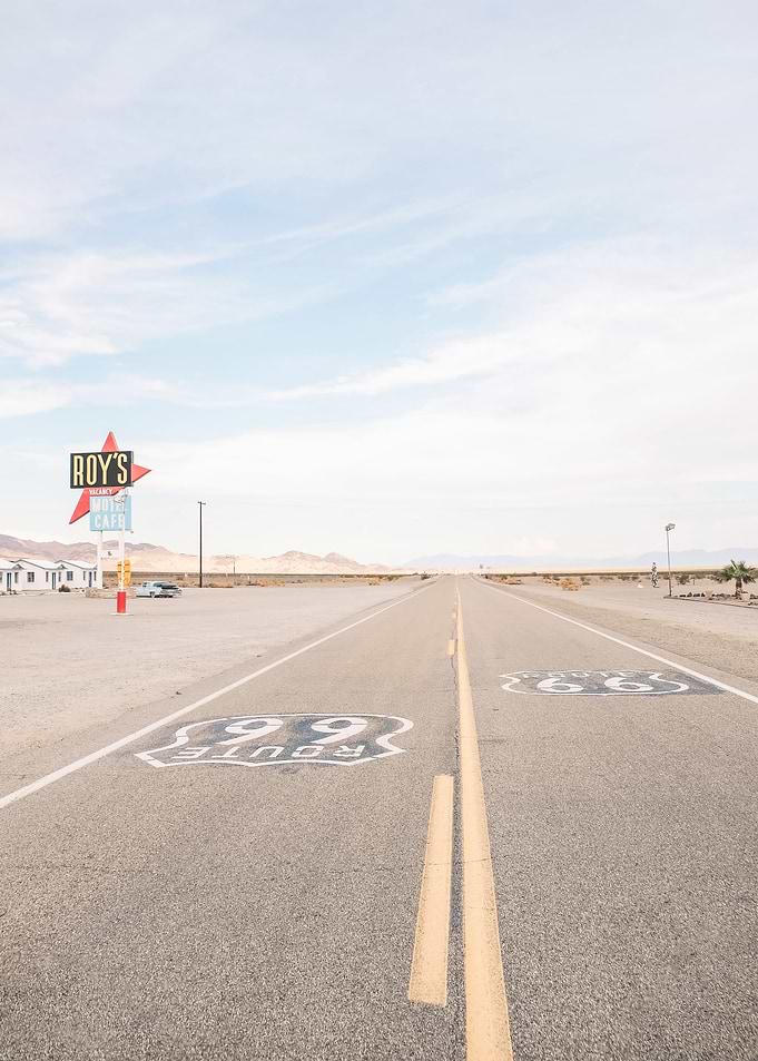 Route 66, USA I Road trip in the desert landscapes of retro vintage America, California and Arizona along the neon gas station Roy's Motel and Cafe with pastel summer aesthetic like analog film