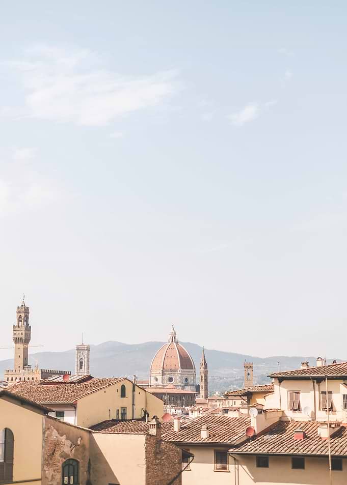 Florence, Italy I Skyline view of italian rooftops and Duomo Santa Maria del Fiore cathedral church with summer pastel aesthetic in sunny orange tones for living la dolce vita under the sun blue sky
