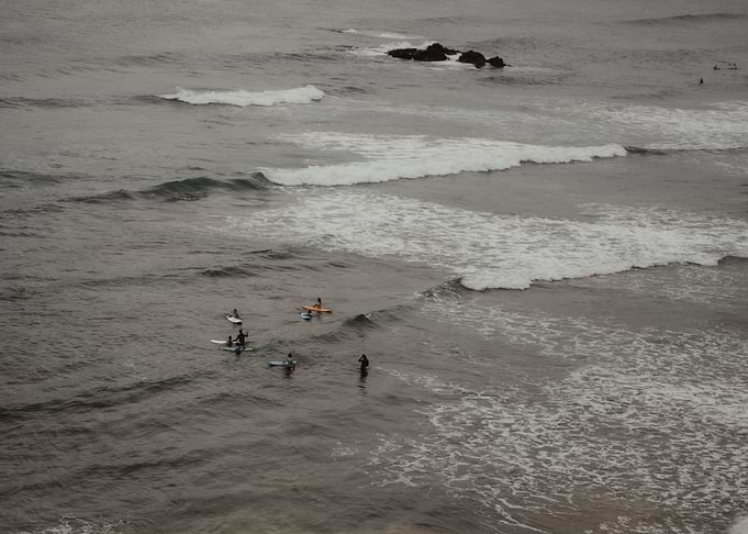Surfers in the Ocean in Ericeira Portugal OU