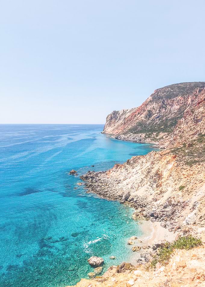 Milos, Greece I Wild boho nature mountain view and turquoise blue water on a dreamy beach paradise on Cyclades islands such as Santorini or Mykonos red beach overlooking the Mediterranean Sea view