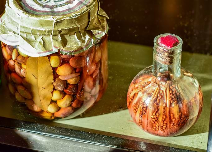 Large jar of olives and bottle of pickled peppers