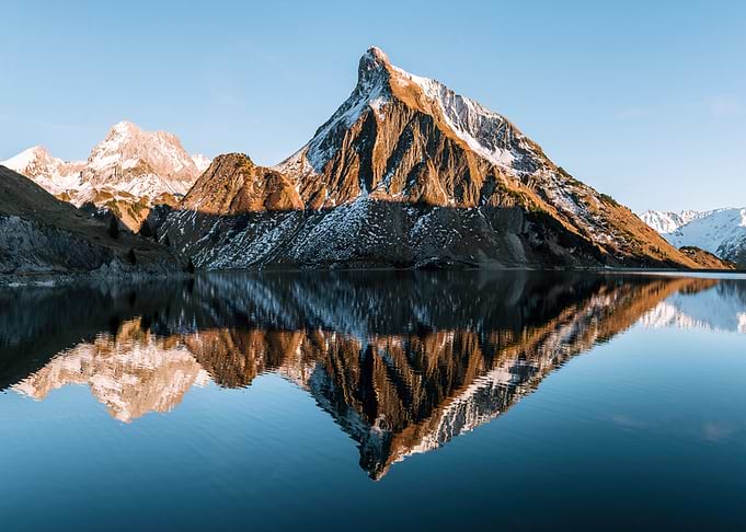 Symmetrical Mountain Reflection in a Lake at sunset in the alps - Landscape photography