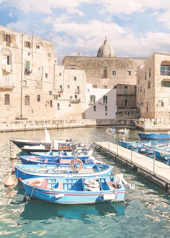 Puglia, Italy I Photography of picturesque port of Monopoli fishing village with crystal blue waters of the Mediterranean sea with its colorful barques boats and historic roman baroque architecture