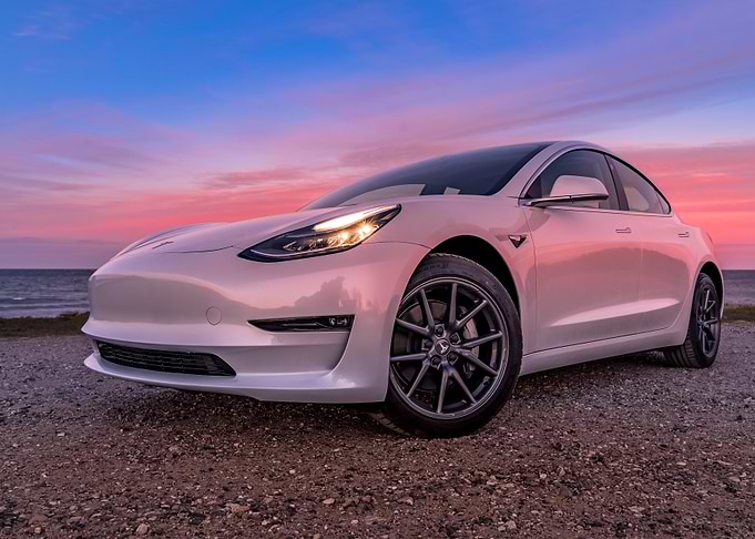 White Tesla Model 3 at Sunset