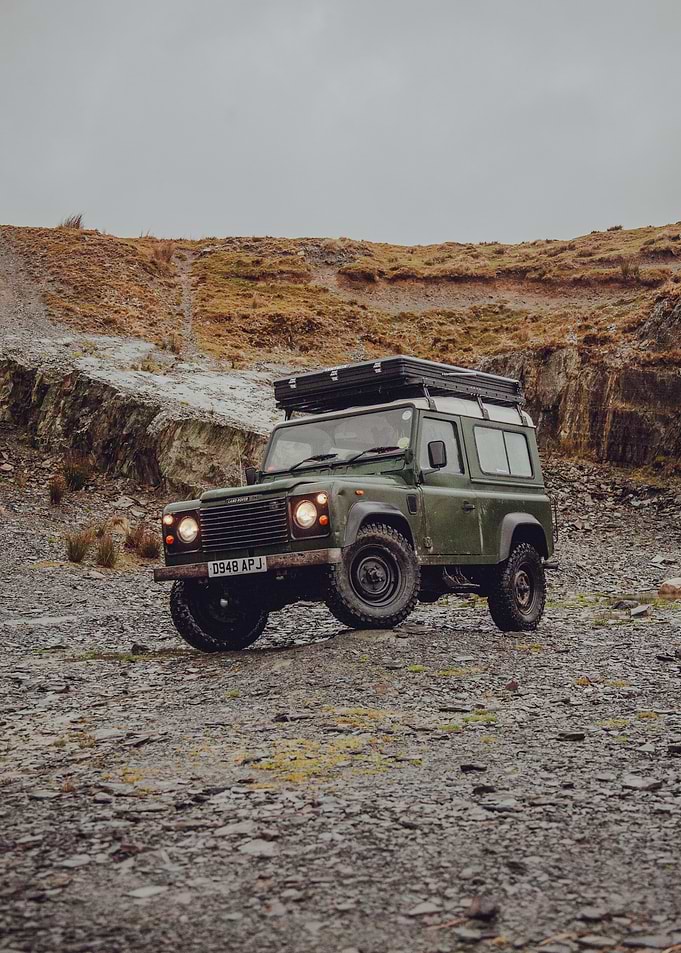 Green Land Rover Defender In The Quarry