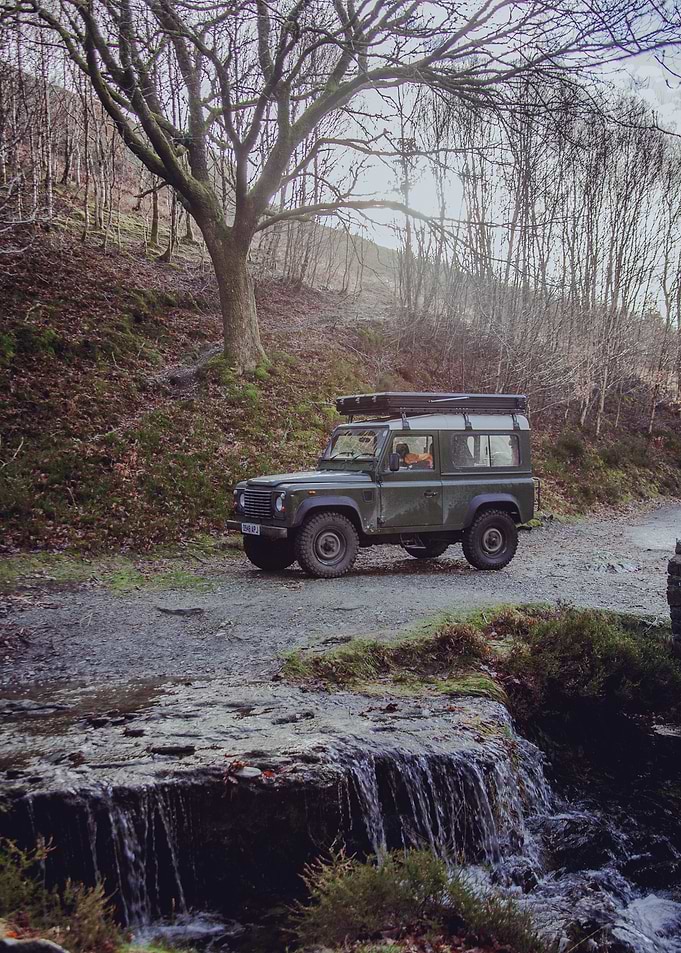Green Land Rover by Waterfall