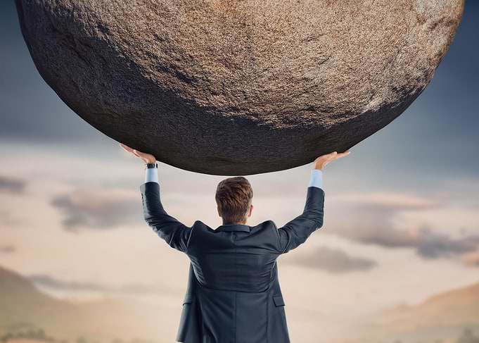 Businessman Lifting Boulder
