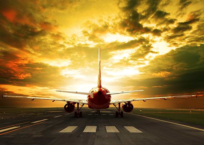 Airplane on Runway at Sunset