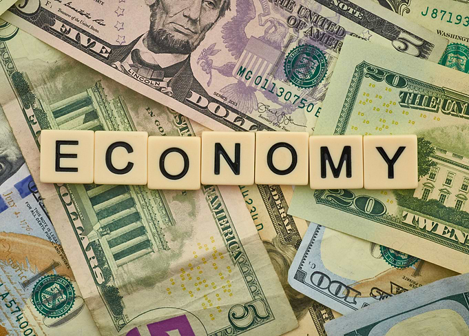 Economy Spelled with Tiles on Money
