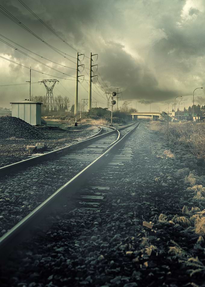 Train Tracks Under Stormy Sky