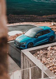 Blue Audi RS3 on Mountain Road