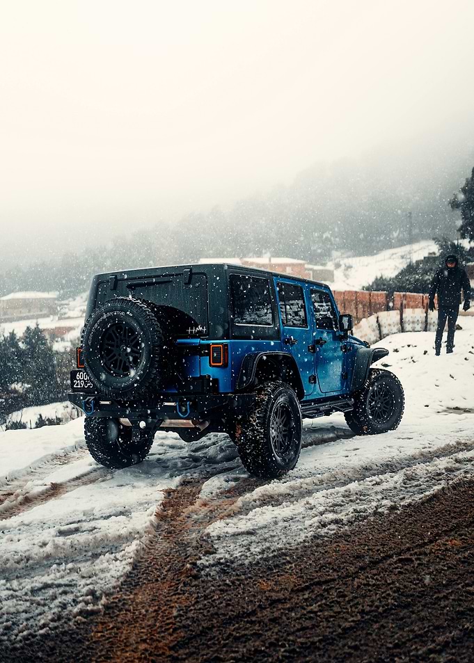Blue Jeep in Snowy Landscape