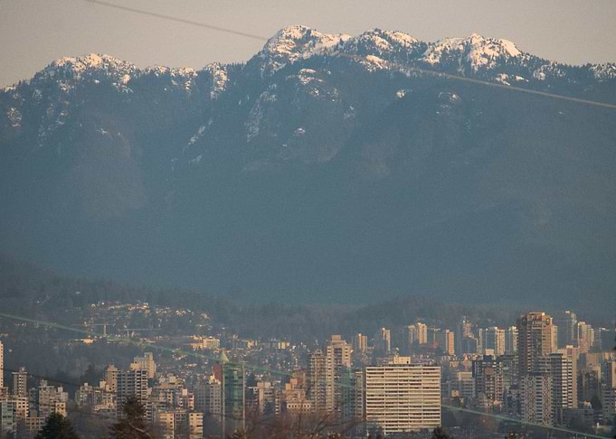 Cityscape with Snowy Mountains