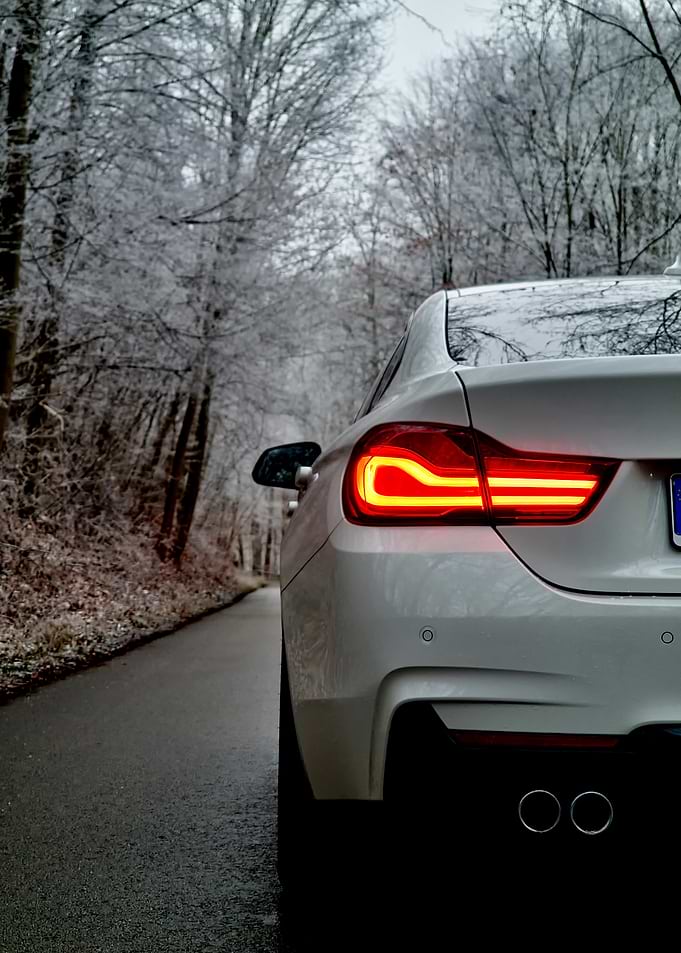 White BMW F36 in Winter Forest