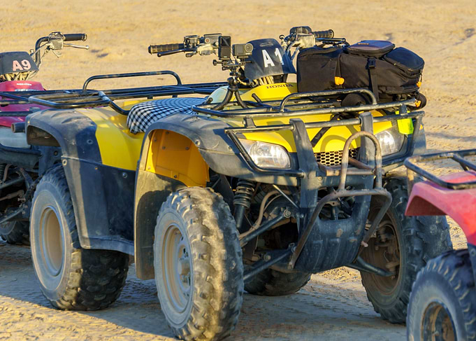 Yellow ATV on Sandy Terrain