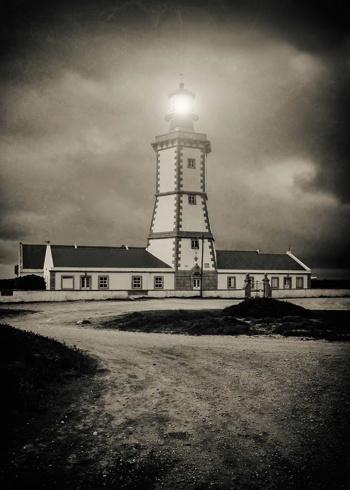 Old lighthouse on a storm night at Dusk. Cabo Espichel Cape Lighthouse Portugal