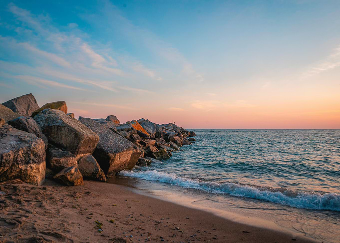 Tranquil Sunset by the Rocky Shore