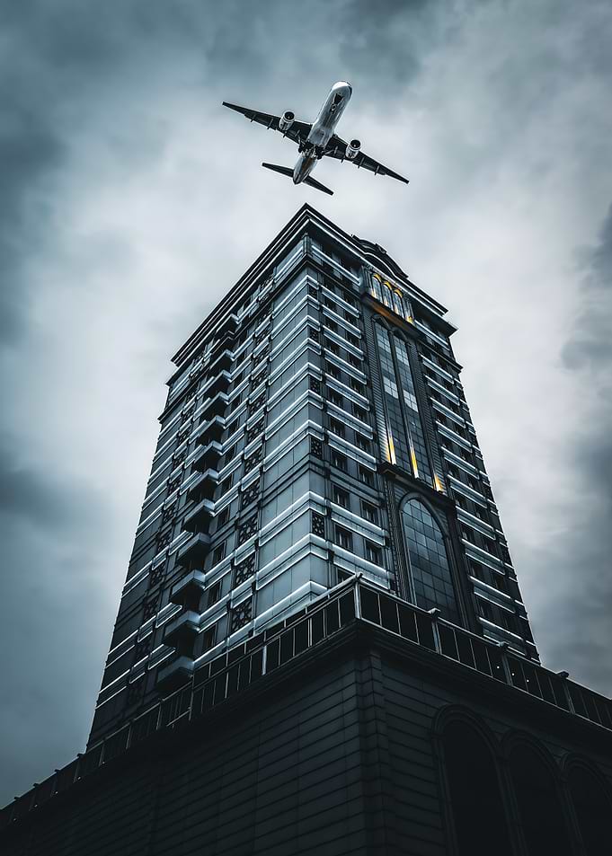 Airplane Over Skyscraper