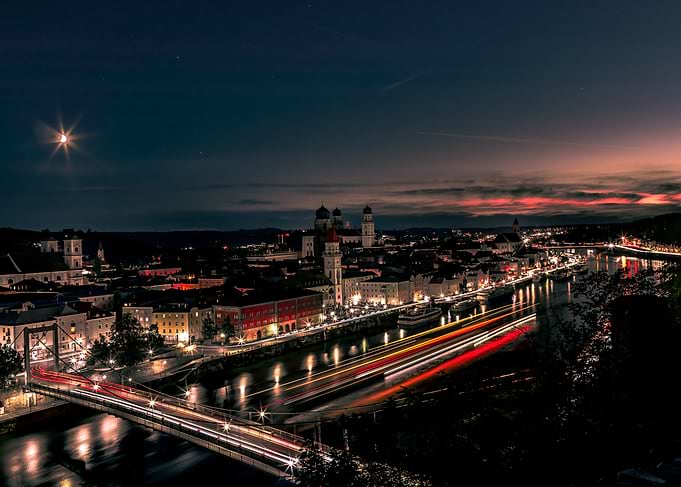 Cityscape at night with colorful light streaks