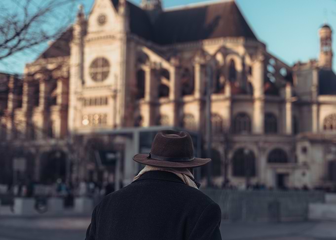 Man in Hat Facing Church