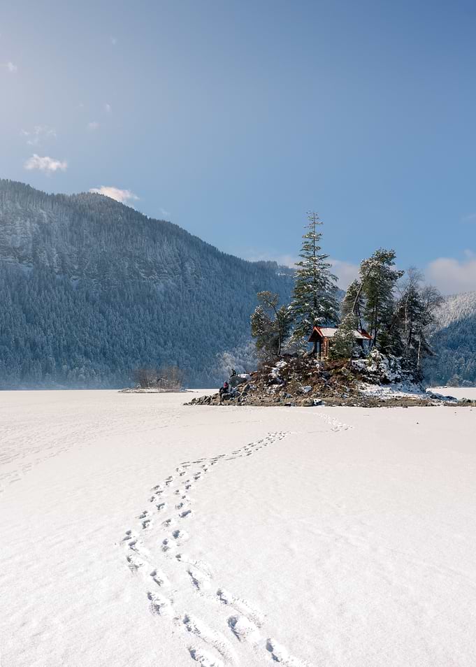 Cabin on frozen lake