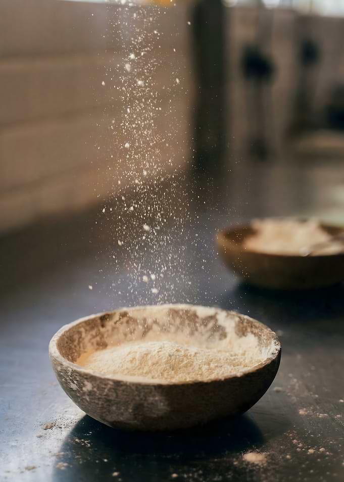 Flour Falling into Bowl