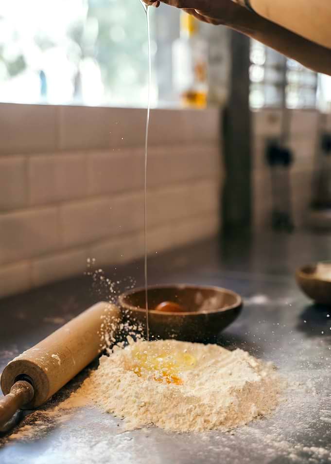 Egg Cracking into Flour