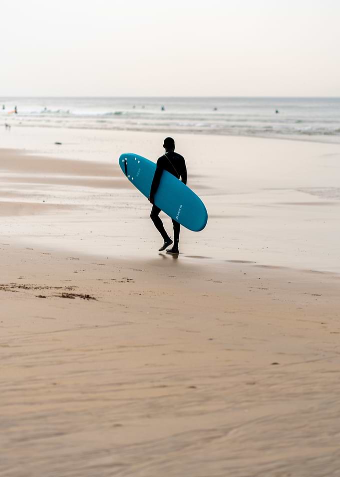 Surfer Walking on Beach