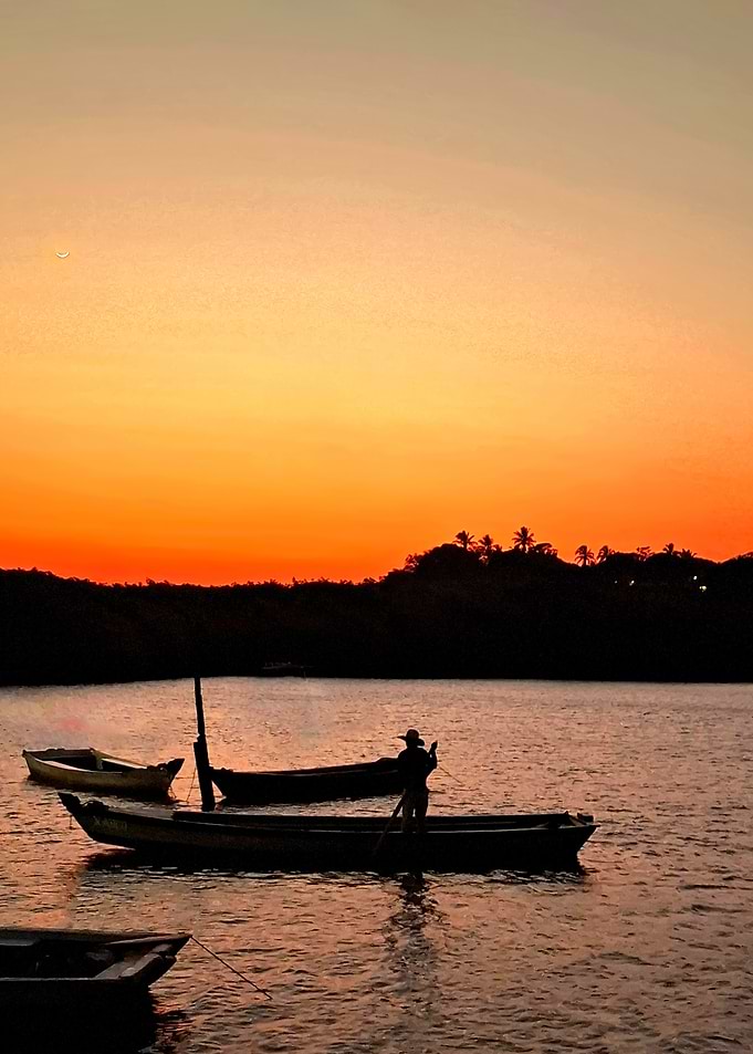 Silhouetted Fisherman at Sunset