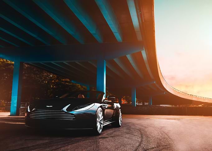 Aston Martin Black Convertible Under Bridge
