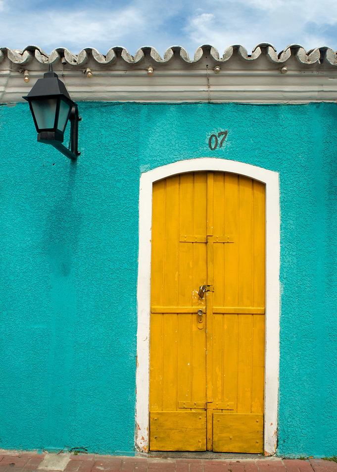 Yellow Door on Turquoise Wall