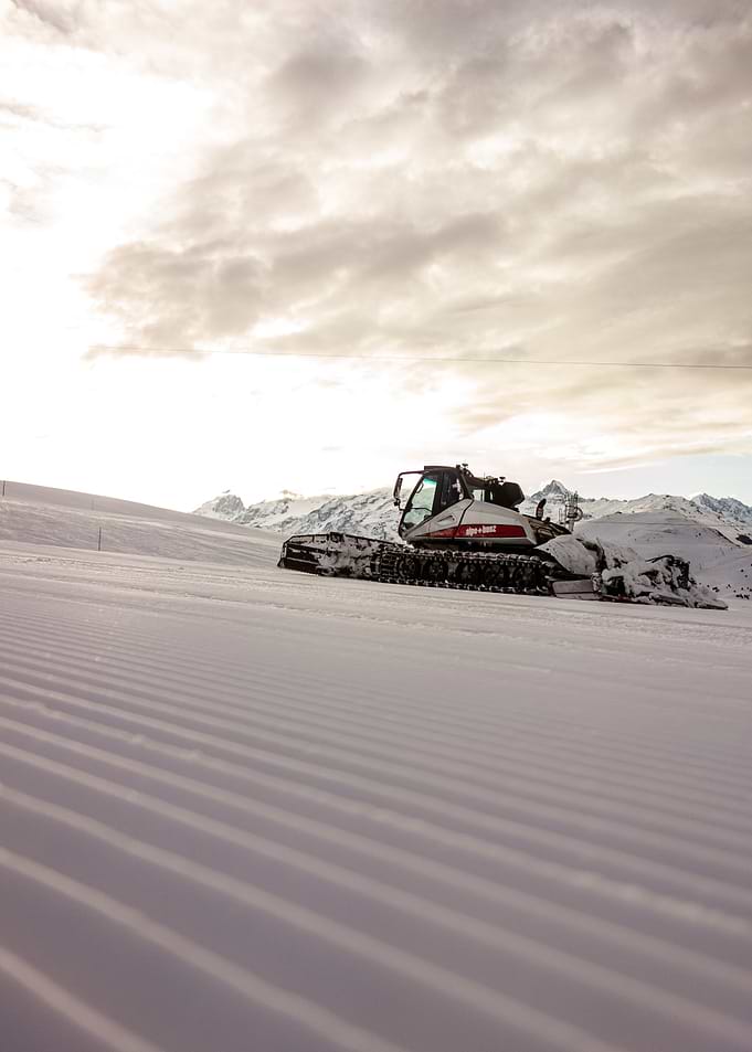 Snowcat on Mountain Slope