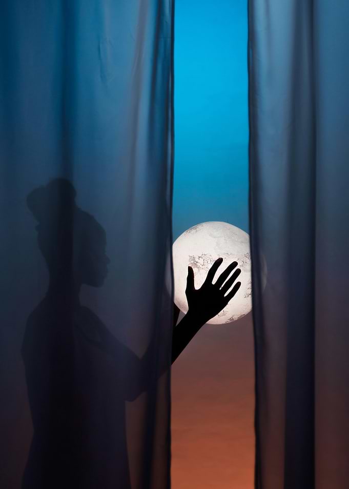 Silhouette Reaching for Moon