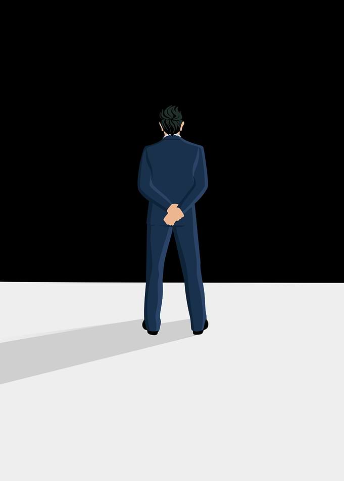 Man in Suit Facing Darkness