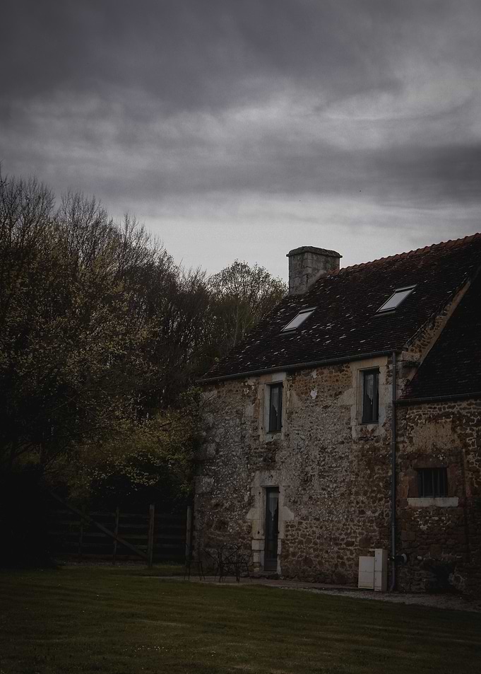 Old house under stormy clouds