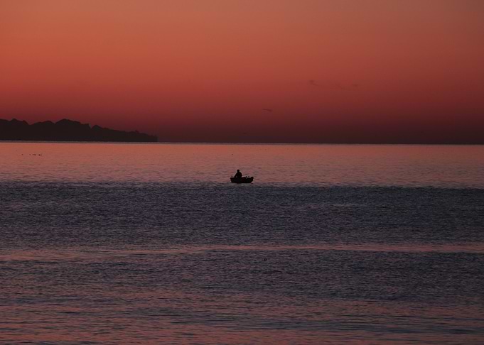 Silhouette of a Boat before Sunrise
