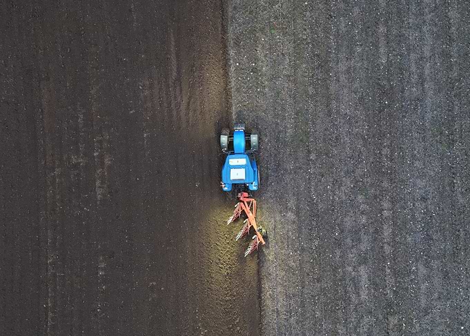 New Holland Tractor Plowing Field